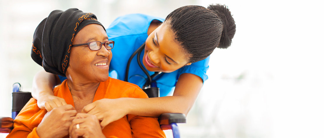 caregiver hugging old woman