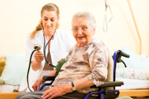 nurse checking blood pressure of her patient