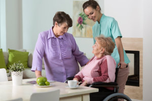 elderly woman in a wheelchair with her caregiver